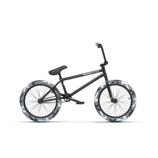 Black RADIO DARKO complete BMX bike with camo-patterned SaltPLUS BURN tires and removable brake mounts.