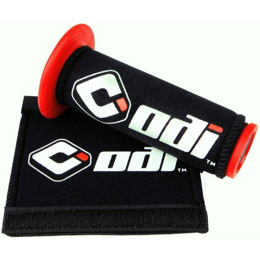 Black ODI grip covers with red handlebar ends and white logo, designed to protect bike grips and clean goggles.