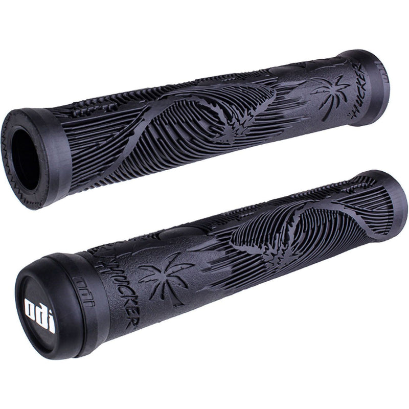 Pair of black ODI BMX grips featuring Mike Hucker signature flange-less design with beach scene texture and soft vertical ribs for padding.