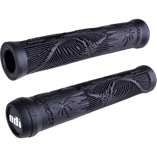 Pair of black ODI BMX grips featuring Mike Hucker signature flange-less design with beach scene texture and soft vertical ribs for padding.