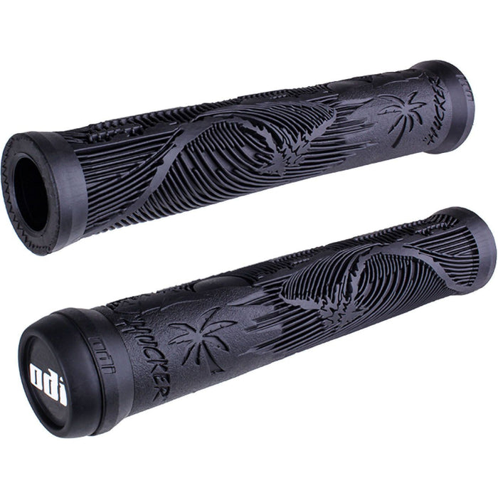 Pair of black ODI BMX grips featuring Mike Hucker signature flange-less design with beach scene texture and soft vertical ribs for padding.