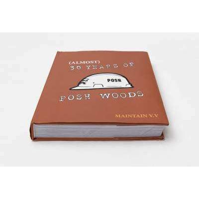 Hardcover book titled "30 YEARS OF POSH WOODS" with brown cover and white text featuring a helmet illustration