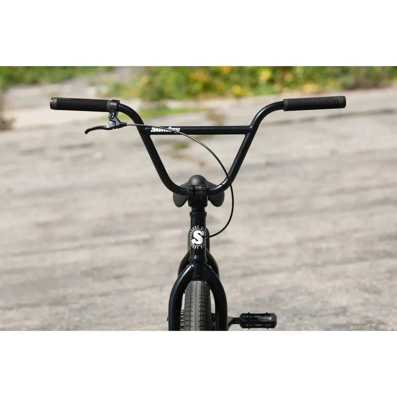 Front view of Sunday Scout 20" BMX bike with black frame, Odyssey Springfield brakes, and signature grips.