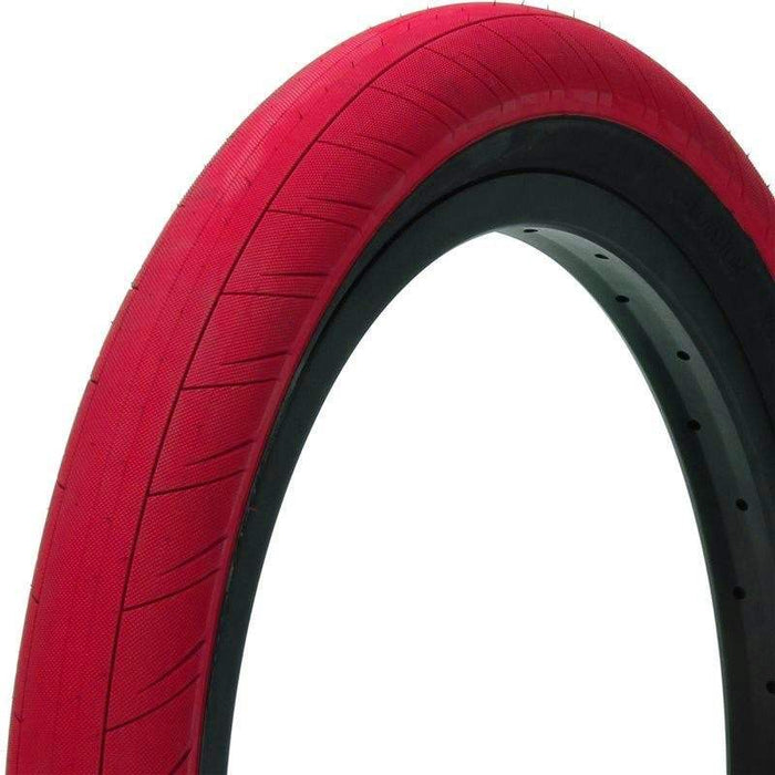 Red Primo Churchill tire with durable tread and black inner rim for enhanced traction and stability.