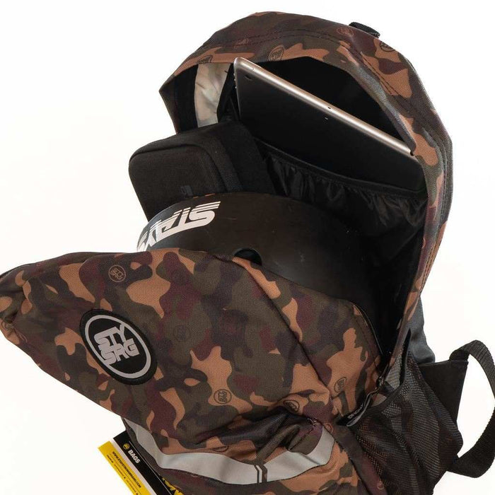 Stay Strong V3 Icon Backpack in camouflage pattern with multiple compartments holding a 17-inch laptop and helmet