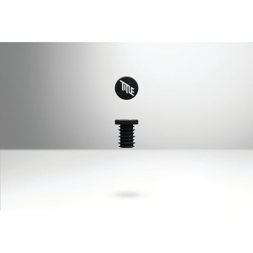Black TITLE MTB FORM bar end grips with logo, designed for seamless fit and clean cockpit look on mountain bike handlebars.