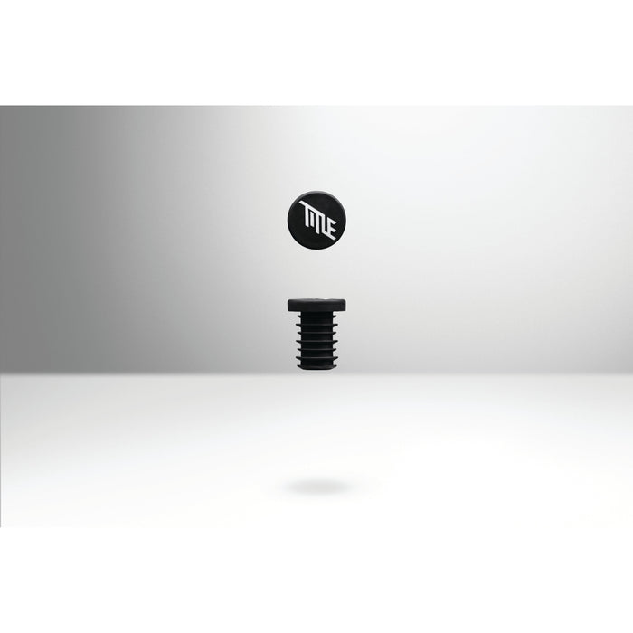 Black TITLE MTB FORM bar end grips with logo, designed for seamless fit and clean cockpit look on mountain bike handlebars.