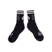 Pair of black ÉCLAT 08 socks with white stripes and number design, made from cotton blend materials
