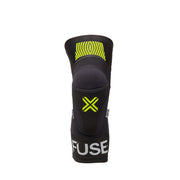 FUSE OMEGA KNEE PAD in black/yellow, featuring lightweight breathable Lycra, SAS-TEC foam insert for impact protection, and strapless design.