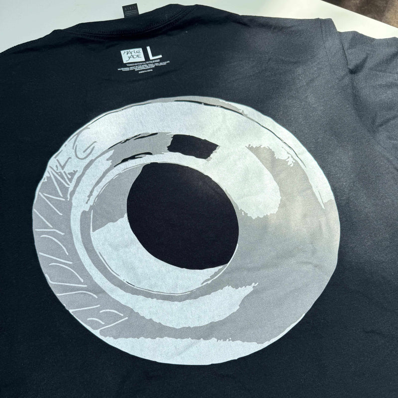 Black MARIE JADE X BUDDY MFG Grind The World T-shirt with circular graphic print on the back and boxy fit design