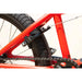 Close-up of the matte fire engine red Sunday Primer 20" BMX bike rear wheel with Odyssey Springfield U-brake and sealed cassette hub.