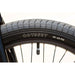 Close-up of Odyssey tire on Sunday Primer 20" BMX bike wheel with 35-65 PSI pressure range.