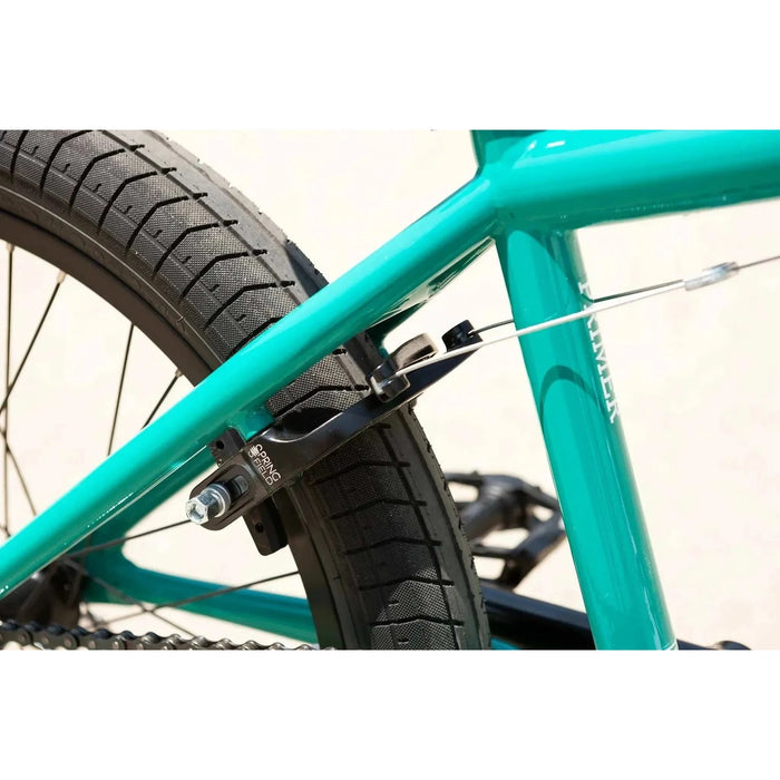 Close-up of teal Sunday Primer 20" BMX bike frame with black Odyssey Springfield U-brake and Path Pro tire