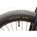 Close-up of ODYSSEY tire on Sunday Primer 20" BMX bike wheel with black rim and spokes.