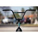 Front view of Sunday Forecaster 20" complete bike handlebar and fork with black grips and blue logo on a blurred outdoor background