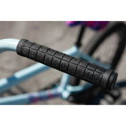 Close-up of black Odyssey Keyboard v2 grip on matte sky blue Sunday Forecaster Ross 20" complete bike handlebar.