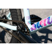 Close-up of the chain and chromoly frame on the matte sky blue Sunday Forecaster Ross BMX bike with branded decals.