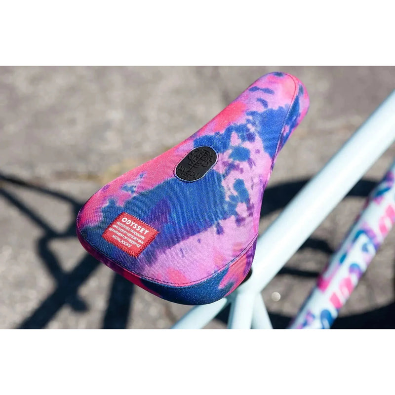 Close-up of tie-dye pink and blue Odyssey Aaron Ross saddle on Sunday Forecaster Ross BMX bike.