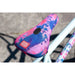 Close-up of tie-dye pink and blue Odyssey Aaron Ross saddle on Sunday Forecaster Ross BMX bike.