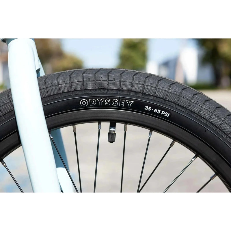 Close-up of Odyssey Path Pro tire and black rim on Sunday Forecaster Ross 20" chromoly bike in matte sky blue