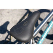 Close-up of Sunday Forecaster black pivotal seat on a chrome BMX bike frame outdoors