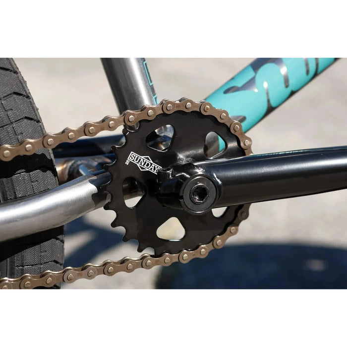 Close-up of Sunday Forecaster BMX bike sprocket and chain on chromoly frame with turquoise branding