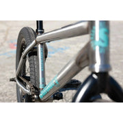 Close-up of Sunday Forecaster 20" chromoly BMX bike frame with turquoise branding and black components.