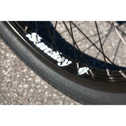Close-up of Sunday Forecaster bike's black Odyssey Path Pro tire and Sunday Lightning rim with white branding