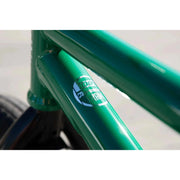 Close-up of green Sunday Forecaster bike frame with 100% chromoly label