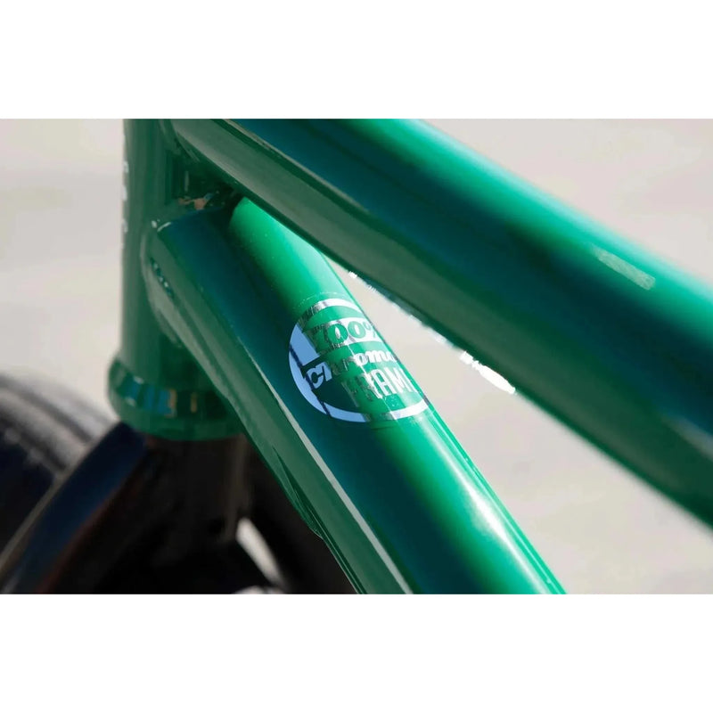 Close-up of green Sunday Forecaster bike frame with 100% chromoly label