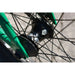 Close-up of the black sealed front hub with spokes on the green frame of the Sunday Forecaster BMX bike.