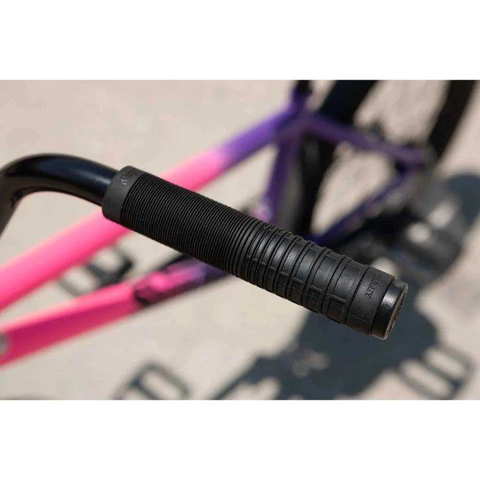 Close-up of black grip handle on Sunday Street Sweeper Jake Seeley signature BMX bike frame with matte hot pink to matte grape fade color.