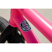Close-up of matte hot pink Sunday Street Sweeper BMX bike frame showing 100% chromoly frame, fork, and handlebar sticker