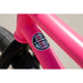 Close-up of matte hot pink Sunday Street Sweeper BMX bike frame showing 100% chromoly frame, fork, and handlebar sticker