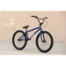 Blue SUNDAY MODEL C 24-inch BMX bike with black tires and handlebars against a beige wall background