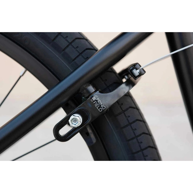 Close-up view of black Odyssey Springfield U-brake mounted on the rear wheel of a Sunday Model C 24" BMX bike.