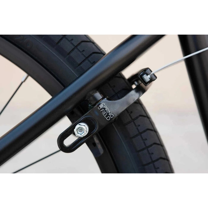Close-up view of black Odyssey Springfield U-brake mounted on the rear wheel of a Sunday Model C 24" BMX bike.