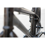 Close-up view of the black Sunday Model C 24" BMX bike frame and rear tire with integrated brake system.
