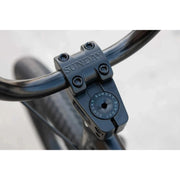 Close-up of black SUNDAY MODEL C bike handlebar stem clamp with embossed SUNDAY logo