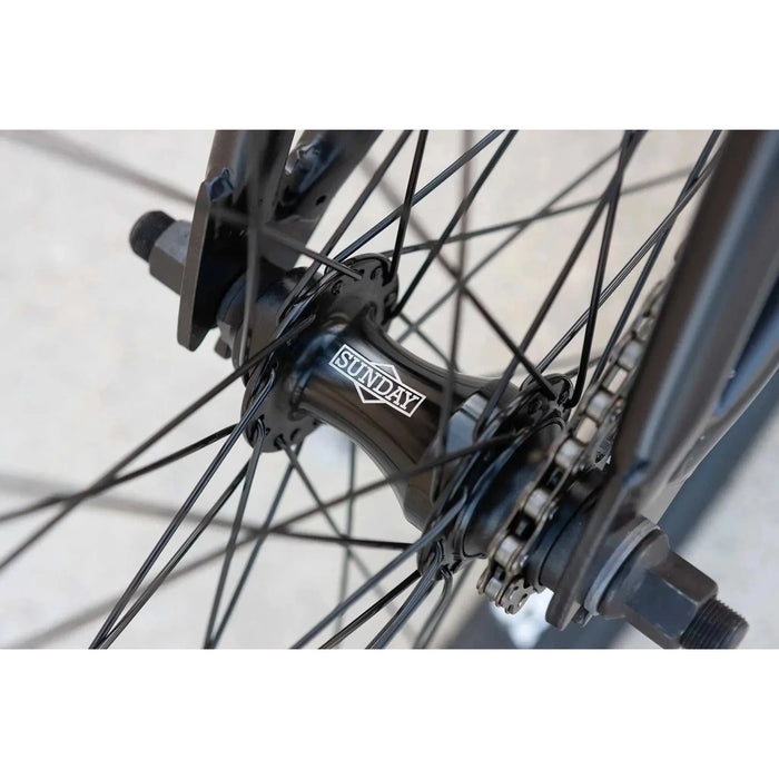Close-up of black SUNDAY MODEL C BMX bicycle rear hub and spokes