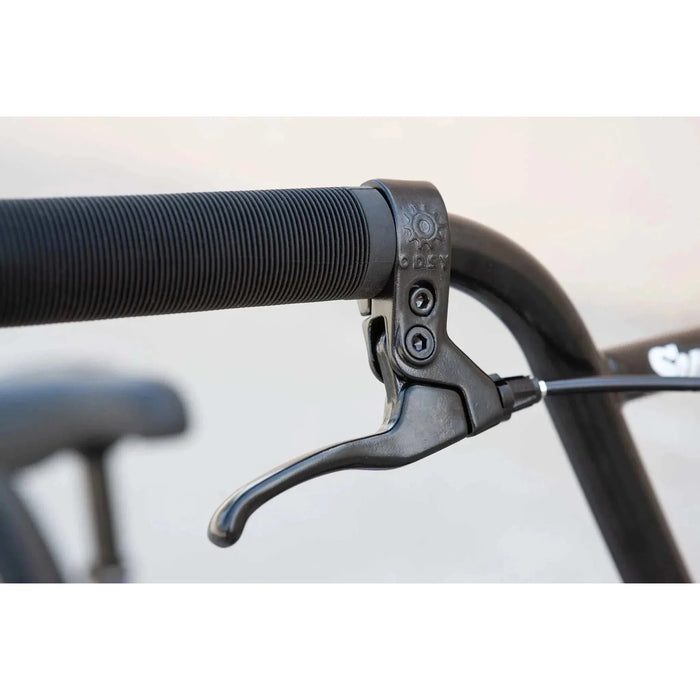 Close-up of black Sunday Model C BMX bike brake lever and handlebar grip