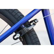 Close-up of black Odyssey Springfield U-brake mounted on blue framed Sunday Model C 24" BMX bike tire
