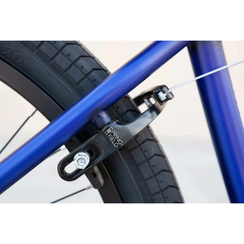 Close-up of black Odyssey Springfield U-brake mounted on blue framed Sunday Model C 24" BMX bike tire