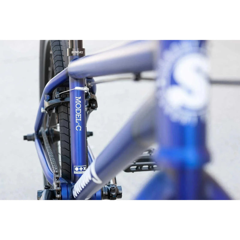 Close-up of blue SUNDAY MODEL C 24" complete BMX bike frame and rear wheel with visible MODEL C branding
