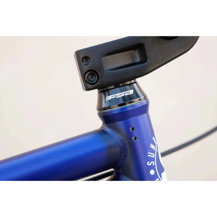 Close-up of blue Sunday Model C 24" BMX bike frame with FSA integrated conical headset and black stem clamp