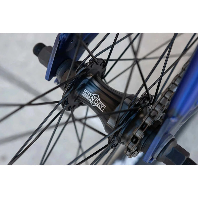 Close-up of black Sunday Model C bike hub and spokes on blue 24" BMX wheel