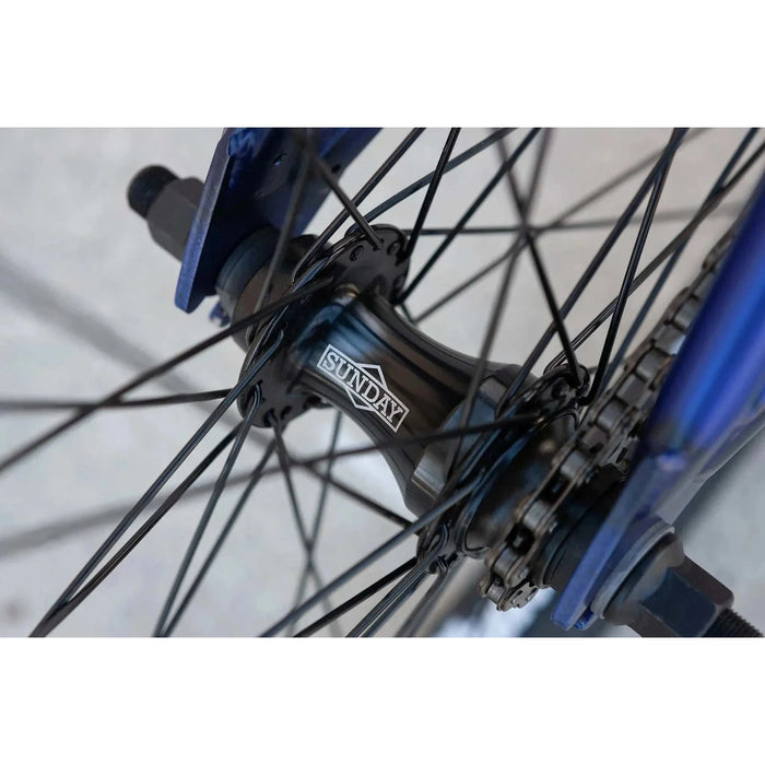 Close-up of black Sunday Model C bike hub and spokes on blue 24" BMX wheel