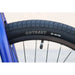 Close-up of Odyssey Pursuit 24-inch BMX tire and black rim on Sunday Model C complete bike.