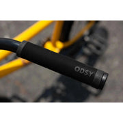 Close-up view of black Odyssey Broc Raiford grip on mustard yellow Sunday EX ARTEAGA BMX bike handlebar