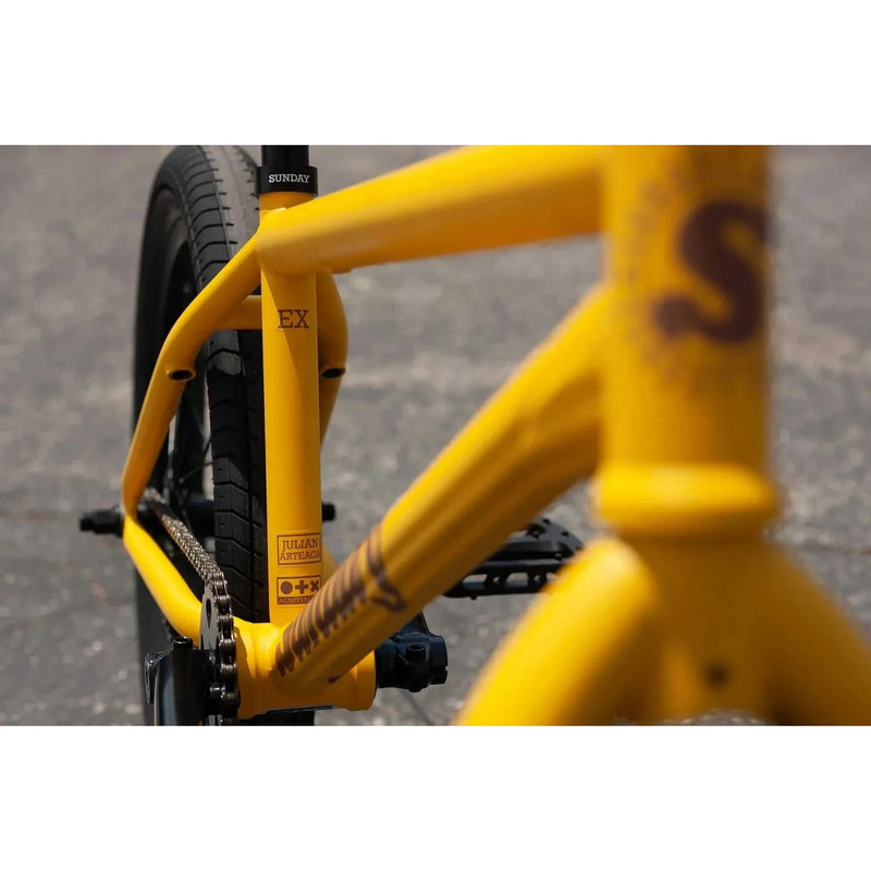Matte mustard Sunday EX Arteaga 20-inch chromoly BMX bike frame and rear tire close-up